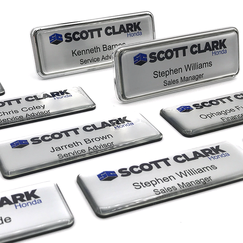 Customizable plastic name badges with various designs and logos, illustrating options for reflecting brand identity