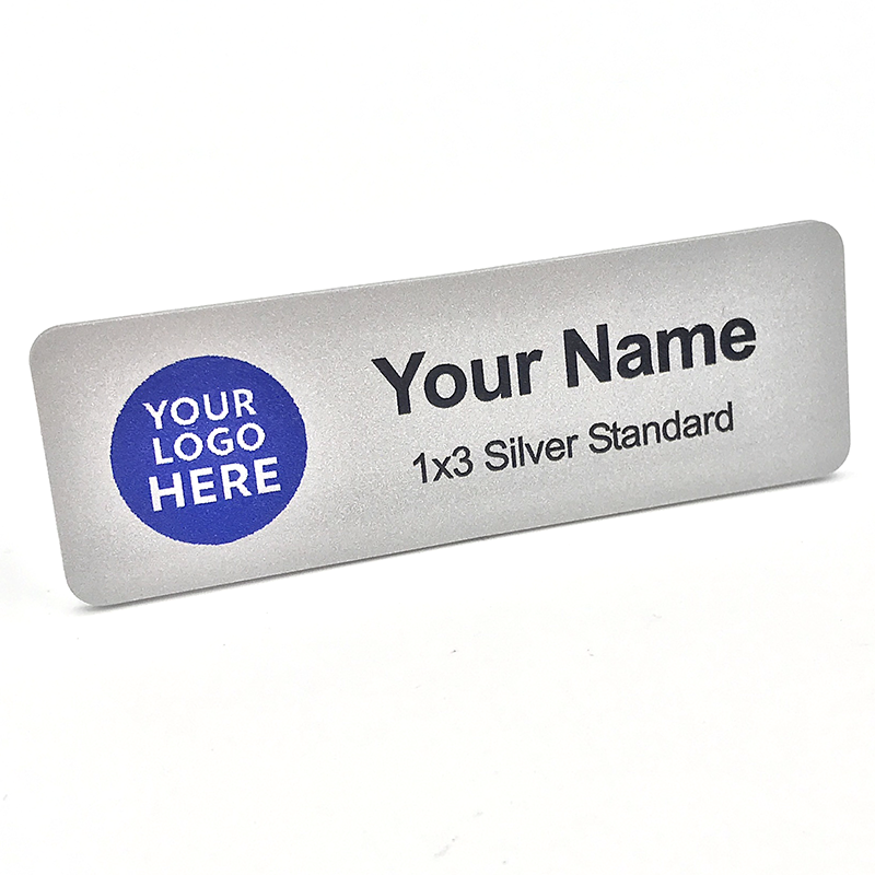 High-quality name badges are displayed on a clean background, showing different colors and styles for professional use